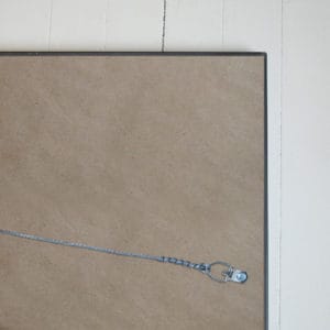 Secure metal cable lock with heart-shaped design on a cork bulletin board for security and organization.