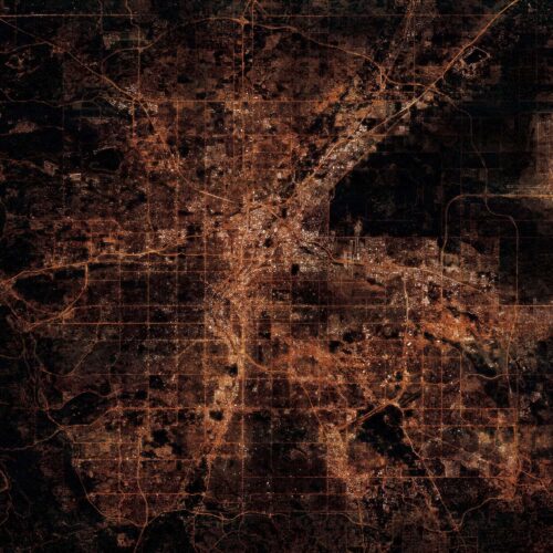 Aerial map view of an urban area at night with illuminated streets and highways highlighting city planning and navigation features.